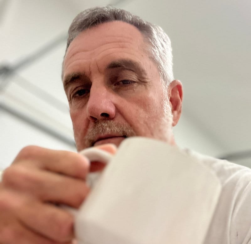 Artist Robert Joyner with coffee cup at 4:30am - the face behind the garage studio art tutorials.