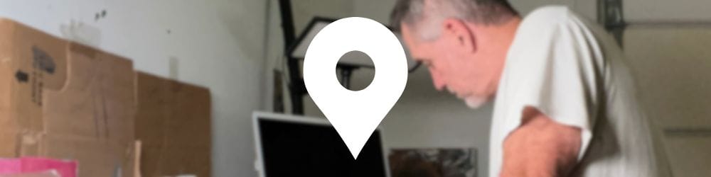 Robert Joyner painting in his garage studio with watercolor and acrylic setup.